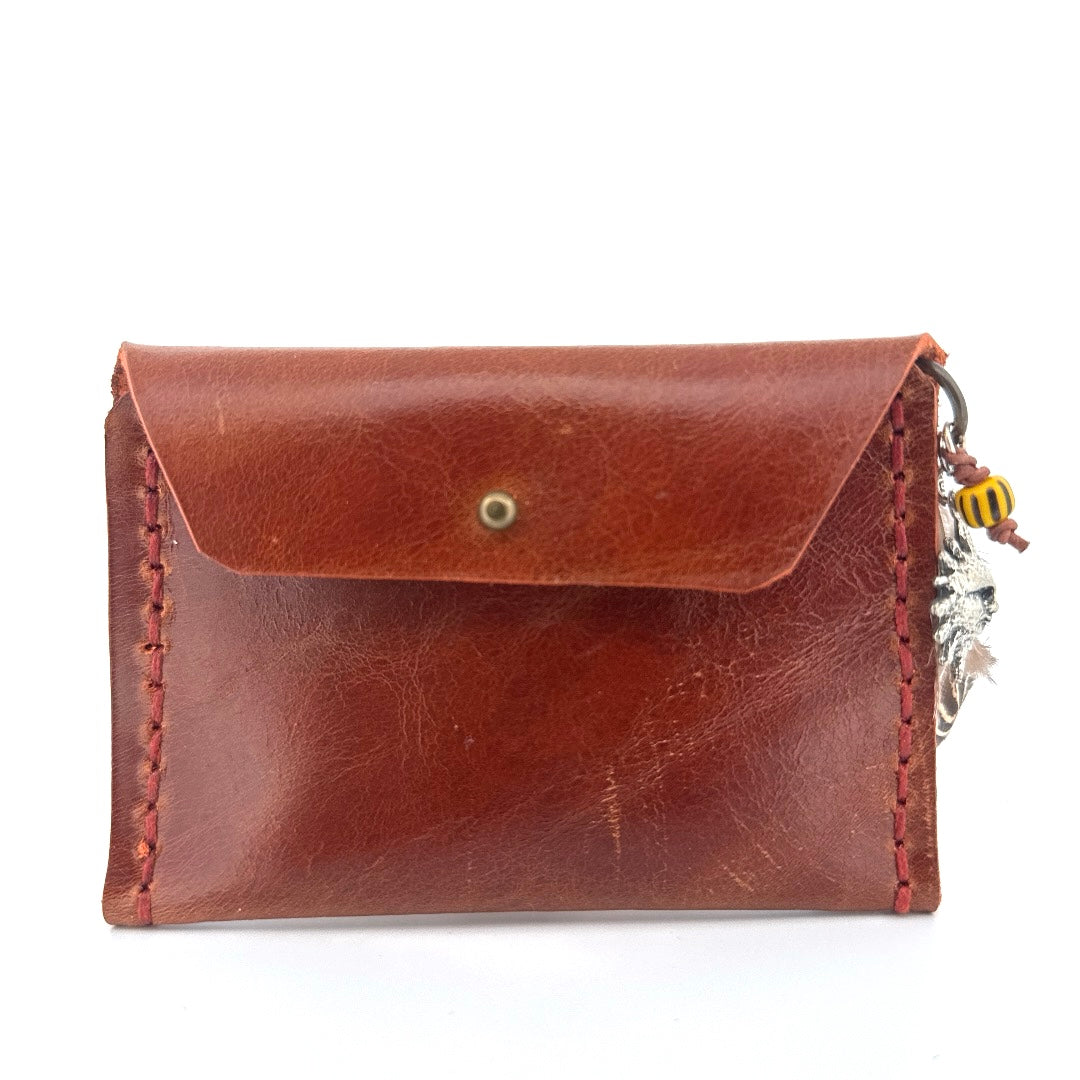 Brown leather pouch with sun charm
