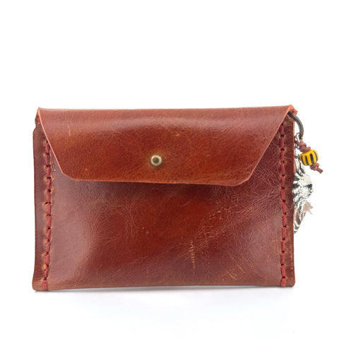 Brown leather pouch with sun charm
