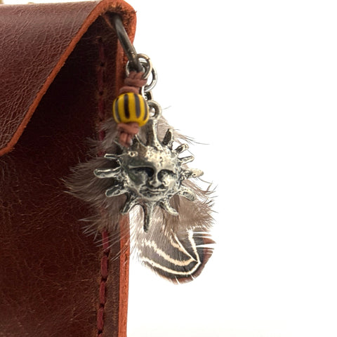 Brown leather pouch with sun charm